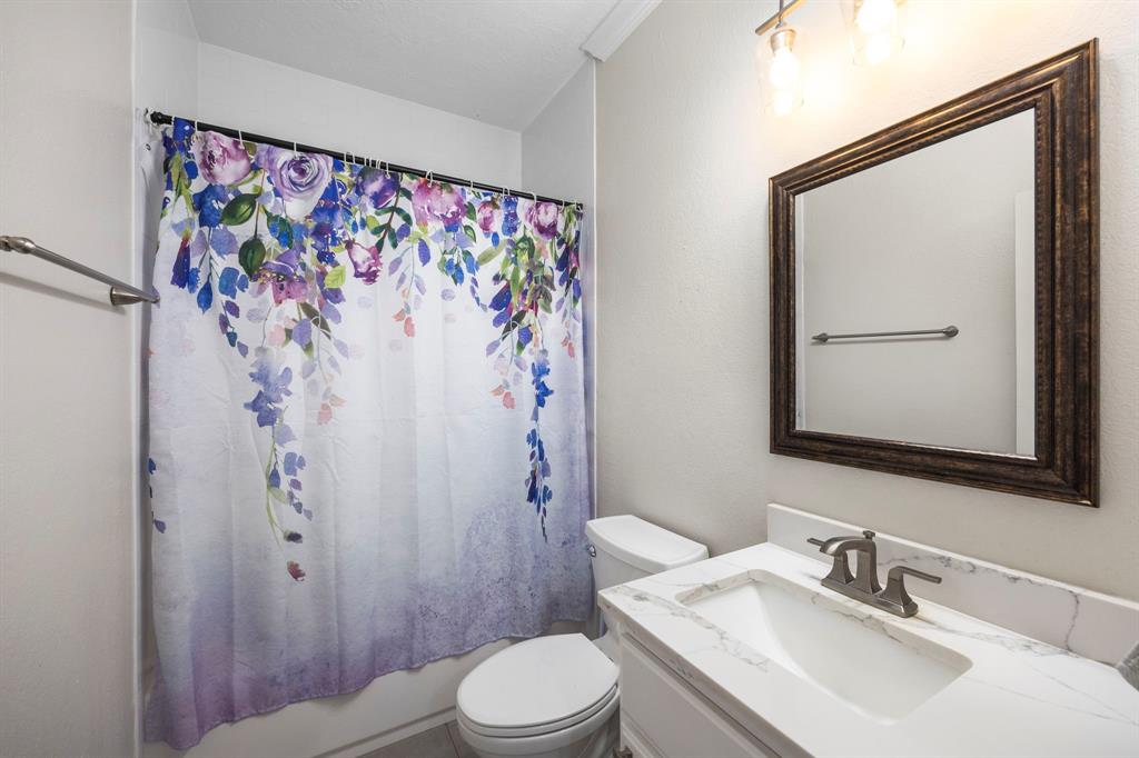 Second full bathroom located near the second and third bedroom with a shower/tub combo.