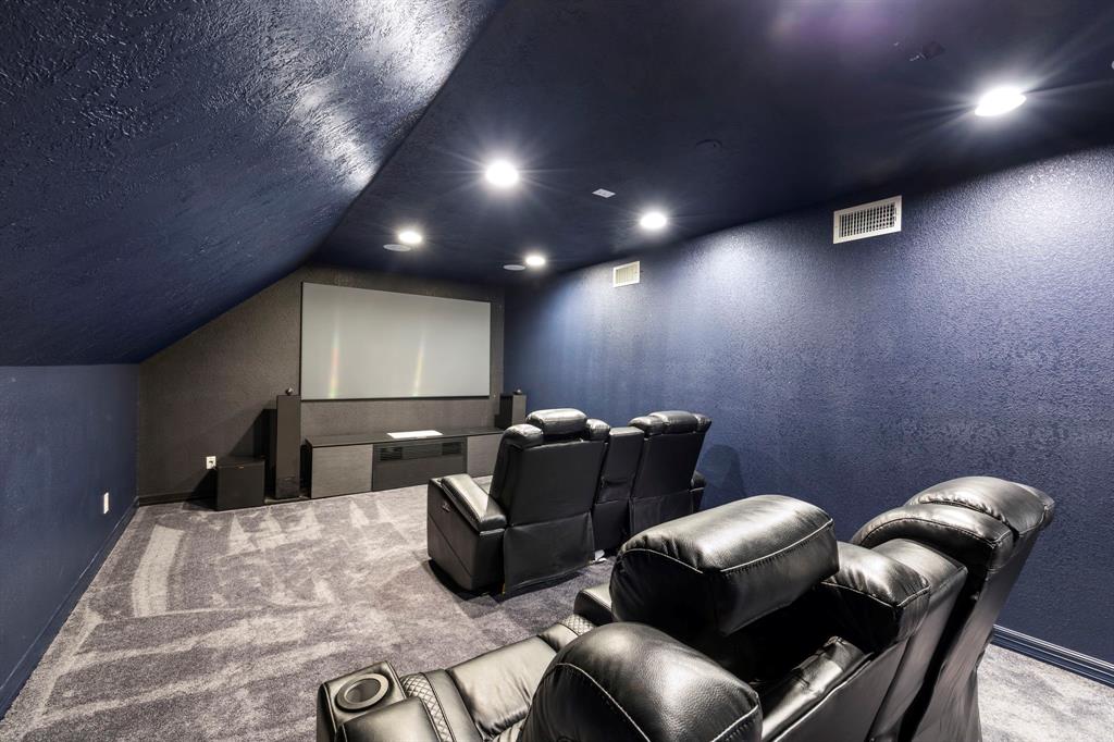 Escape from everyday life in your own private theater room, complete with high-end equipment and a large television screen.