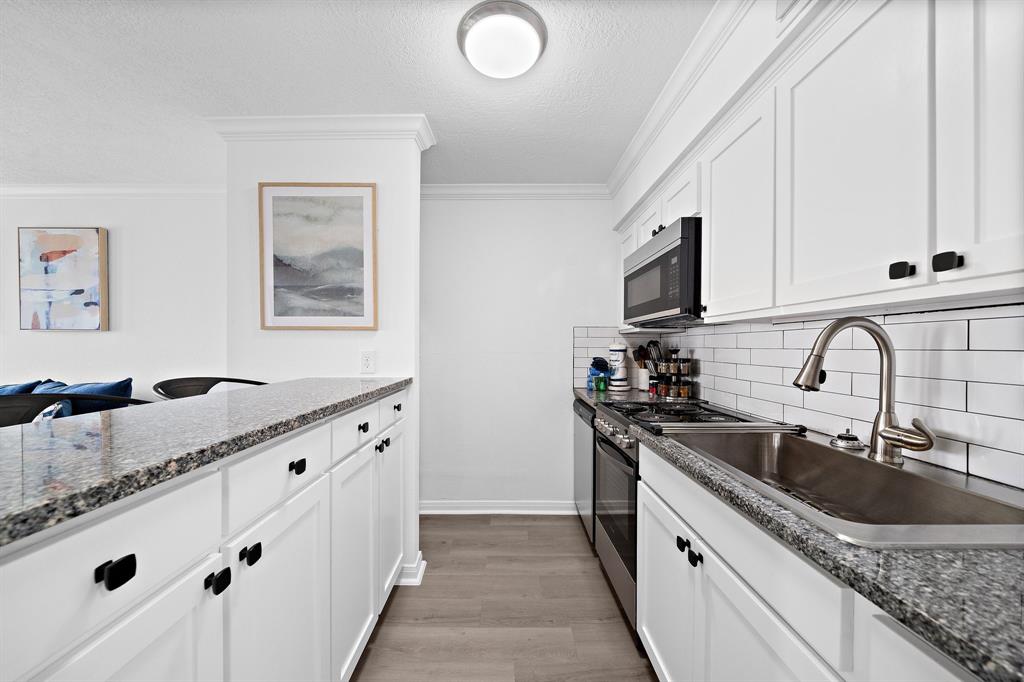 Stainless steel appliances in this adorable kitchen