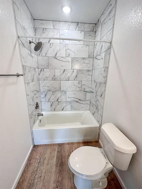 The downstairs bathroom has a tiled bathtub