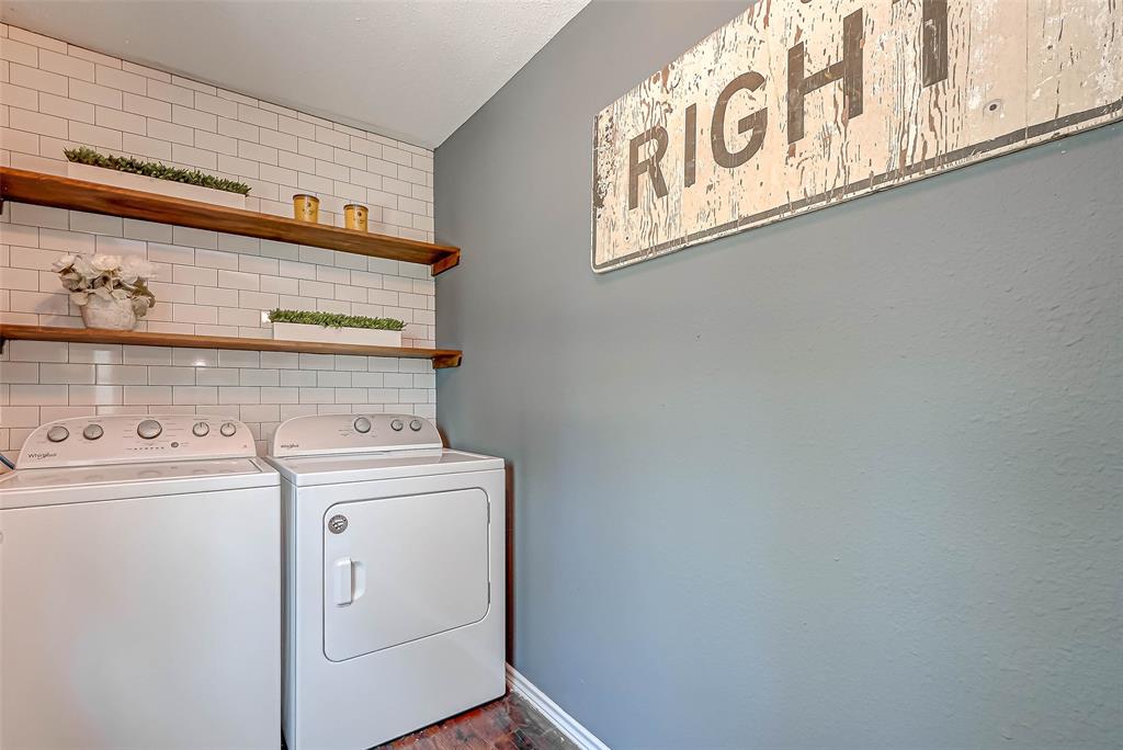 Perfectly tidy laundry room, great colors, tile accent wall and storage shelves.