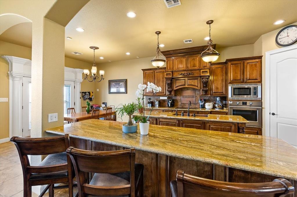 Fabulous Gourmet Kitchen With Large Island*All Surfaces Are Upgraded Granite*Light Fixtures Over The Island.