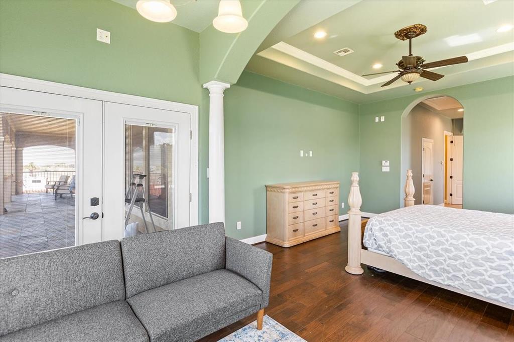 Primary Bedroom & Sitting Area*Wood Floors*Columns, Crown Molding, & Upgraded Fan.