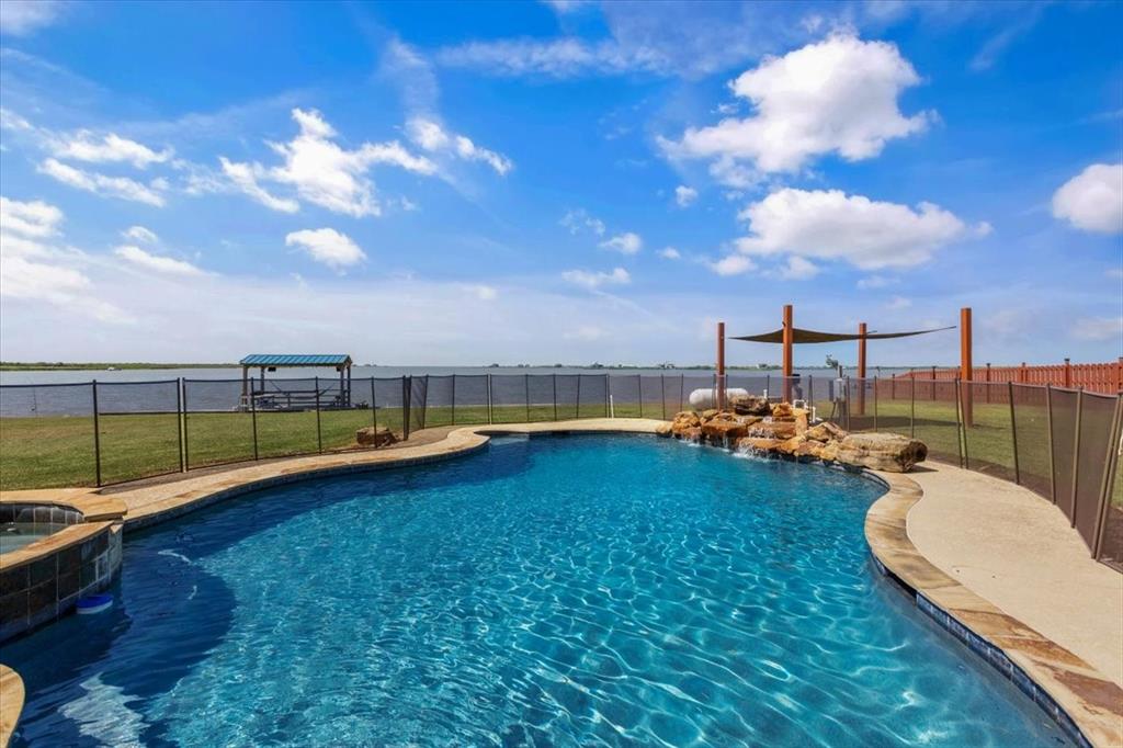 In Ground Pool With Tile Edge, Water Fall, Security Fencing, View Of The Bay.