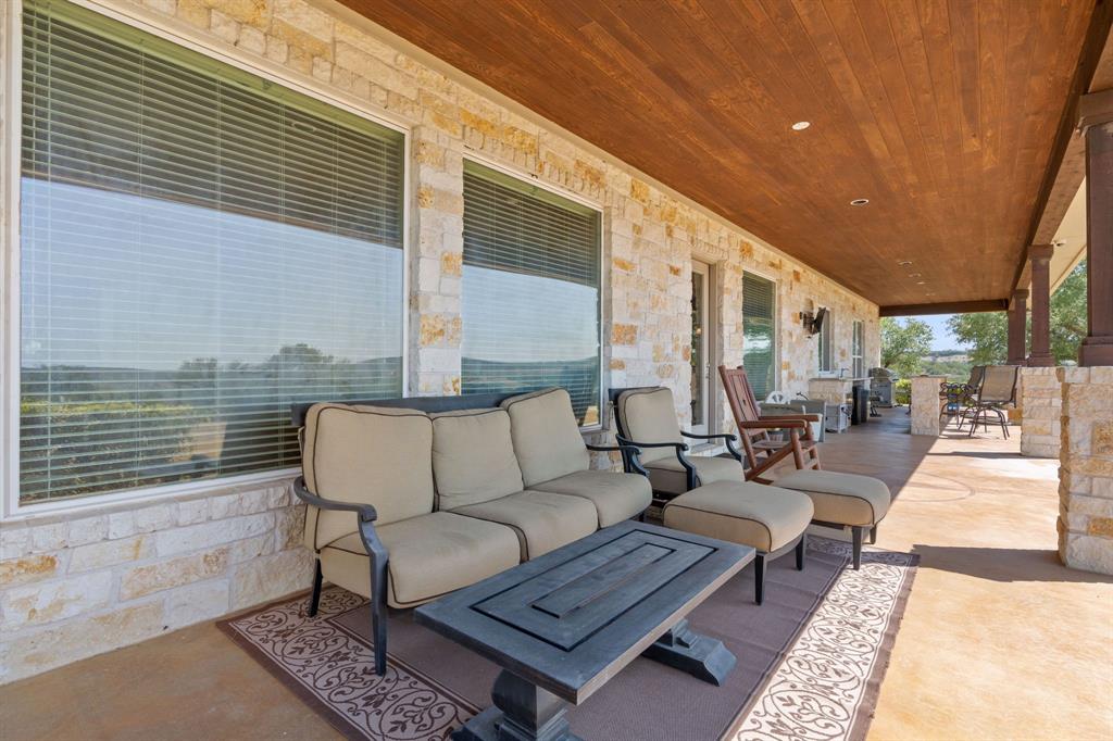 BACK PORCH LENGTH VIEW TOWARD THE OUT DOOR KITCHEN AS YOU SEE A LOT OF TIME RELAXING AND VIEWING ALL THE GAME ACTION AND THE BEAUTIFUL ROLLING HILL COUNTRY COME AND SIT A WHILE
