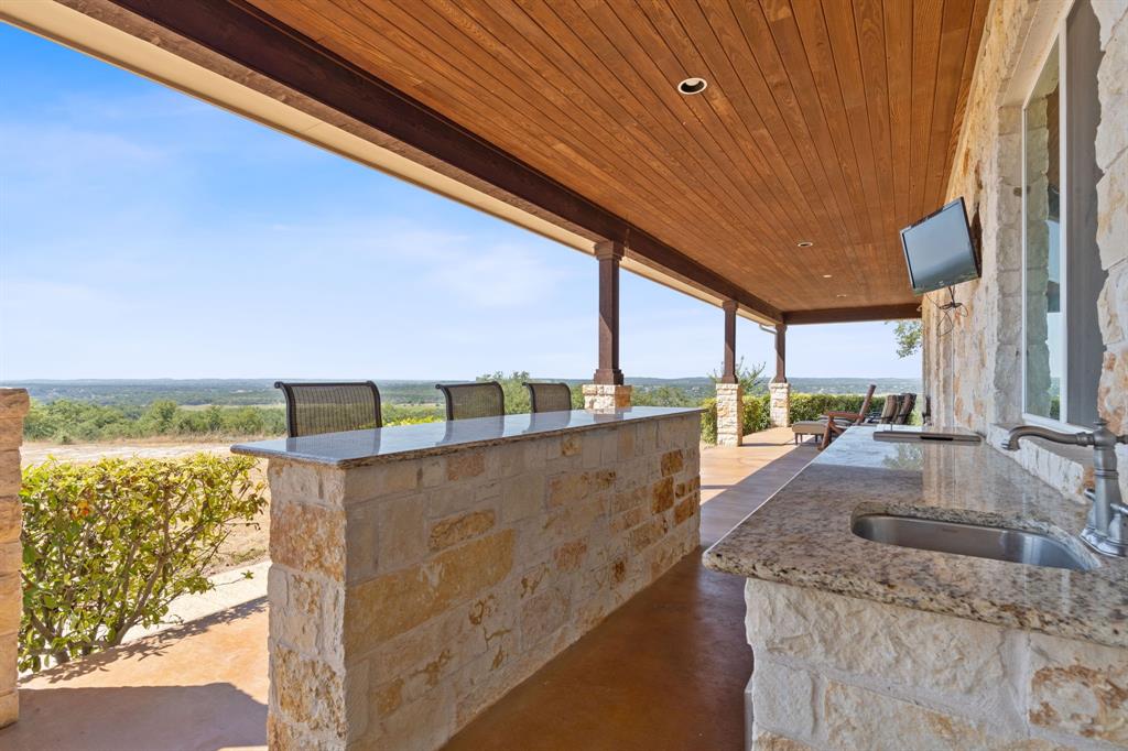 OUT DOOR KITCHEN WITH STAINLES APPLIANCES AUSTIN ROCK AND A FRIG  VIEW LOOKING TOWARD THE COLORADO RIVER