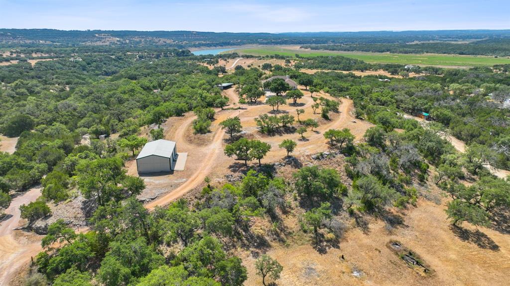 ARIEL VIEW OF THE 10 ACRE TRACT TOWARD THE BARN/SHOP AND THE HOME IS BEHIND THE TREES IN THE CENTER OF PHOTO,   RIVER VIEW AND LAKE SPACE IS THE LIGHT GREEN AREA TO THE  UPPER RIGHT