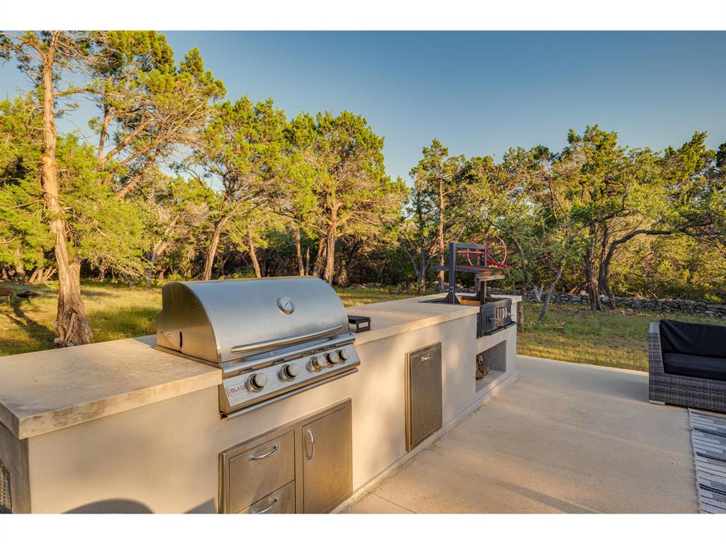 Outdoor grill area next to pool great for hosting cookouts
