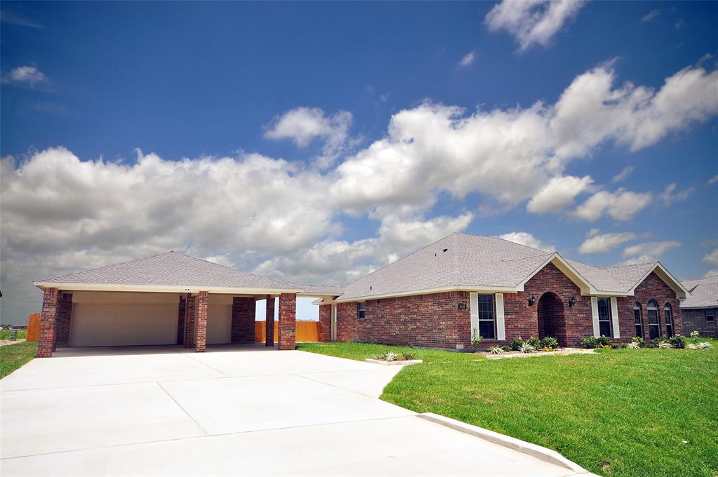 This home features a wide drive to a 6 Car garage with a 3 Car Porte Cohere out front.