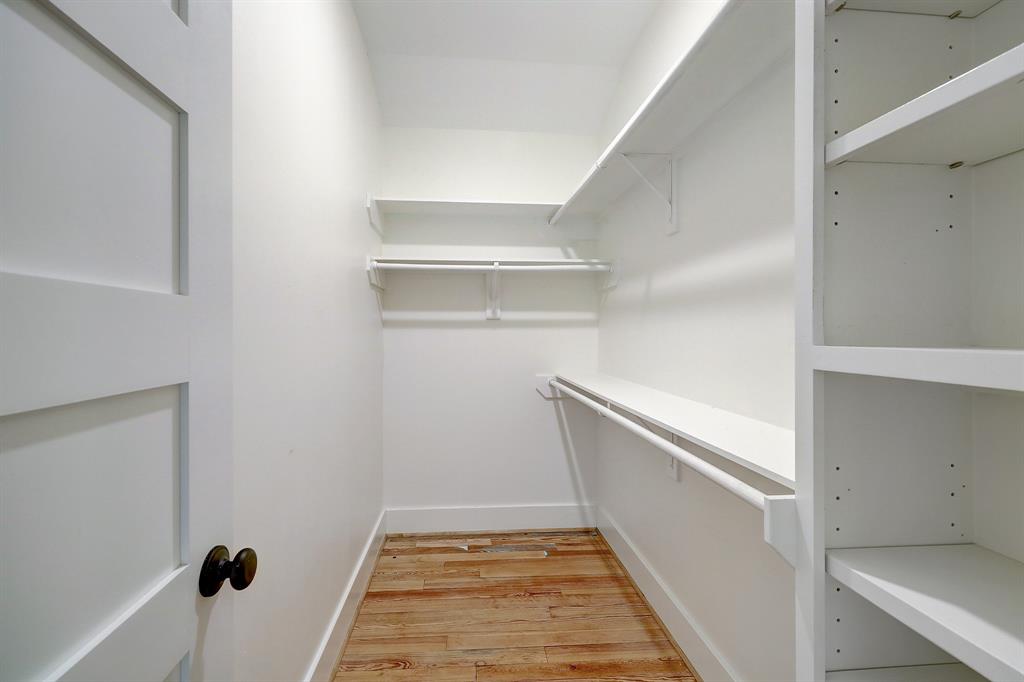 Reclaimed pine floors flow through full walk-in closet with custom built-ins.