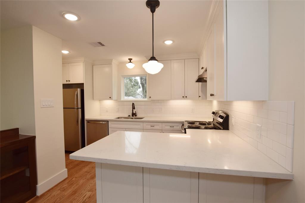 Garage apartment features full huge kitchen with white granite eat-in counter, custom pine cabinets, full stainless appliances and pantry.