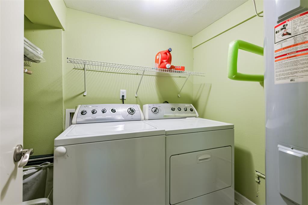 Full size washer and dryer downstairs with storage racks.