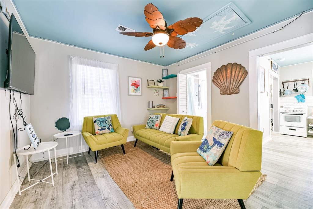 Upstairs in the family room, there is a stylish designer ceiling fan and a large-screen TV.
