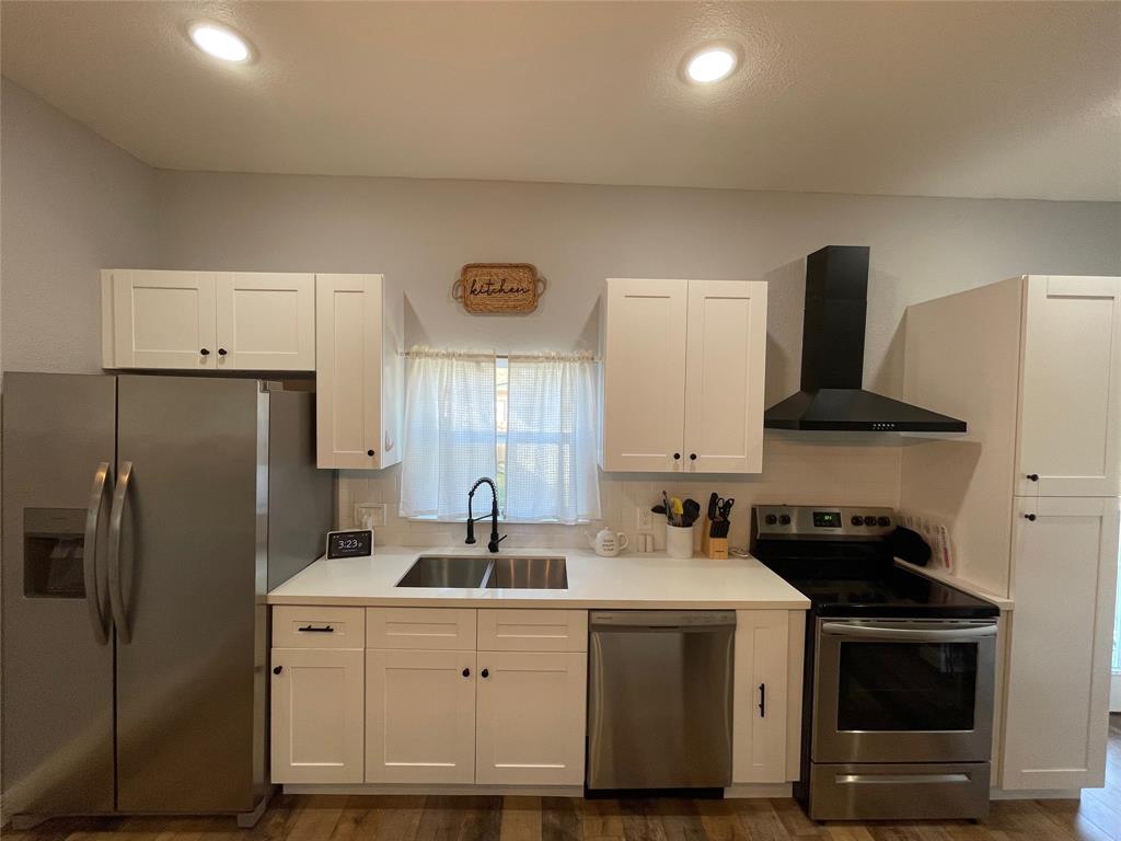 Kitchen includes stainless steel double sink. Kitchen window offers a great view of the outside deck and inviting backyard.  Kitchen is fully stocked with dishes, flatware and some small appliances.