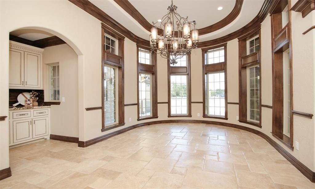 Host elegant dinners in this fabulous formal dining room complete with double crown moulding, beautiful tray ceilings and an exquisite chandelier . Plenty of natural light comes in through the wall of windows. Notice the convenient butlers pantry as well!