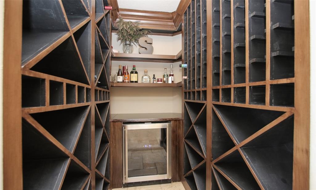 An inviting wine grotto with plenty of built-in wine storage for your wine bottles and a wine chiller!
