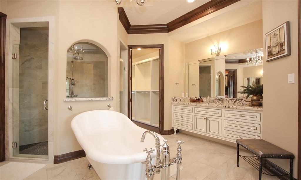 What an amazing primary bathroom! Double sinks, gorgeous clawfoot tub, stunning granite counters, walk-in shower and his/hers separate closets.