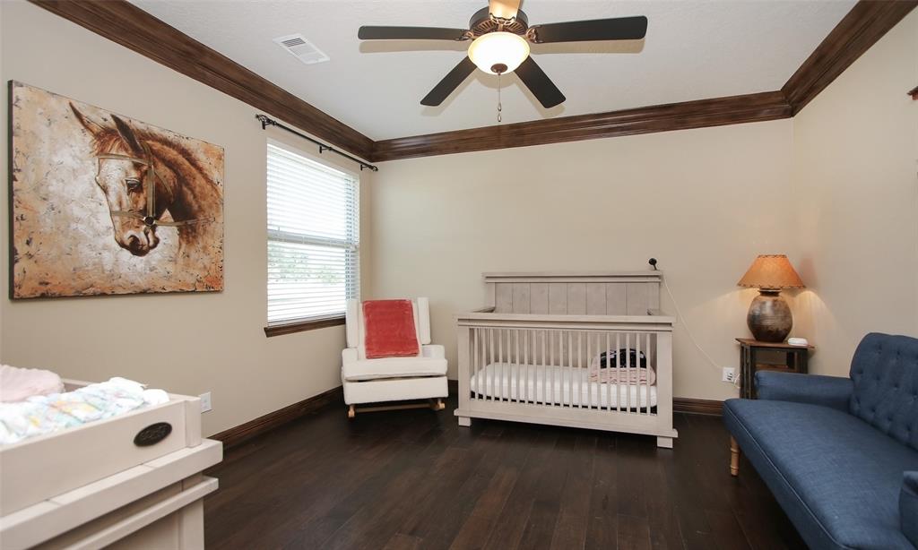 Secondary bedroom has its own bathroom and roomy closet. Wood floors, double wood crown molding are featured.