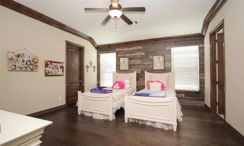 Gorgeous secondary bedroom with a wall of distressed wood accent! Complete with a private bath and nice closet space!
