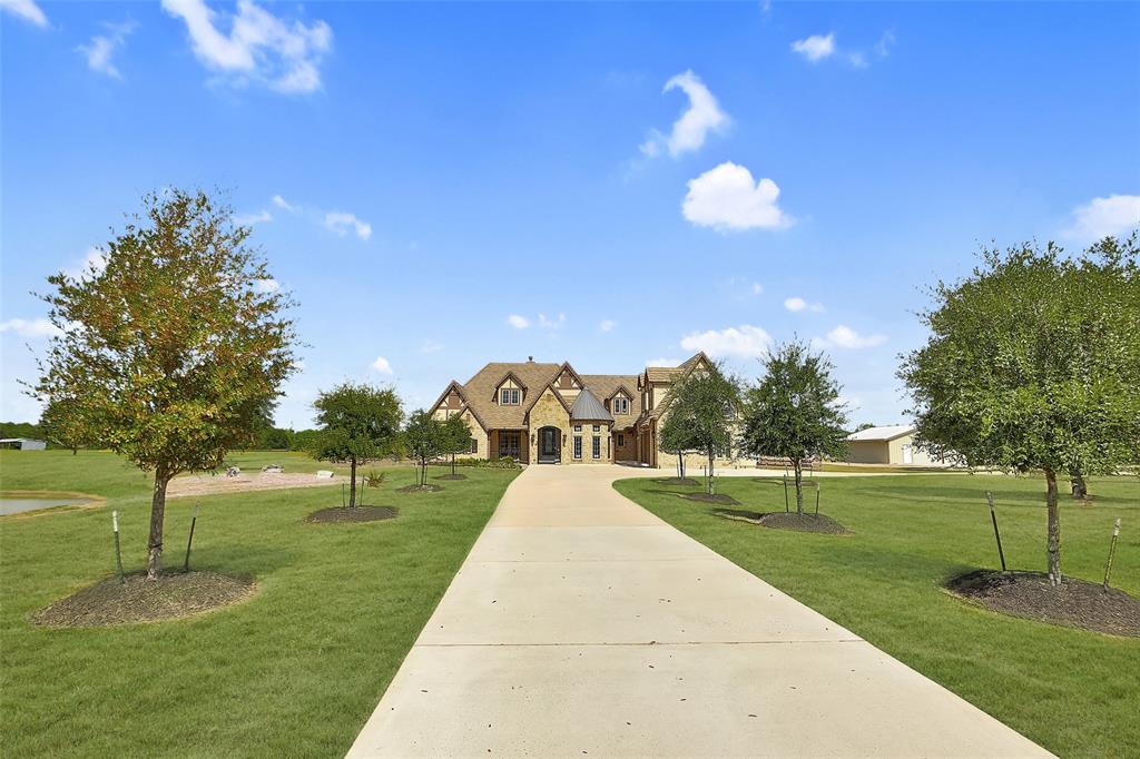 Travel down the long circular driveway to the house. Driveway is lined with trees to welcome your guests!