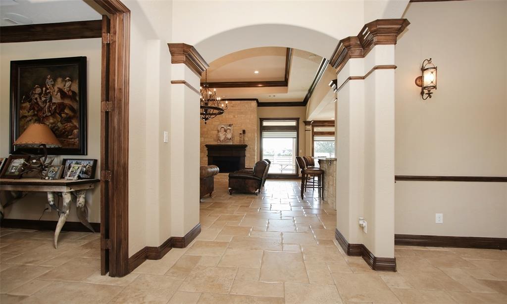 Once you enter you will notice the beautiful double wood crown molding, arched doorway, tile floors and high ceilings.