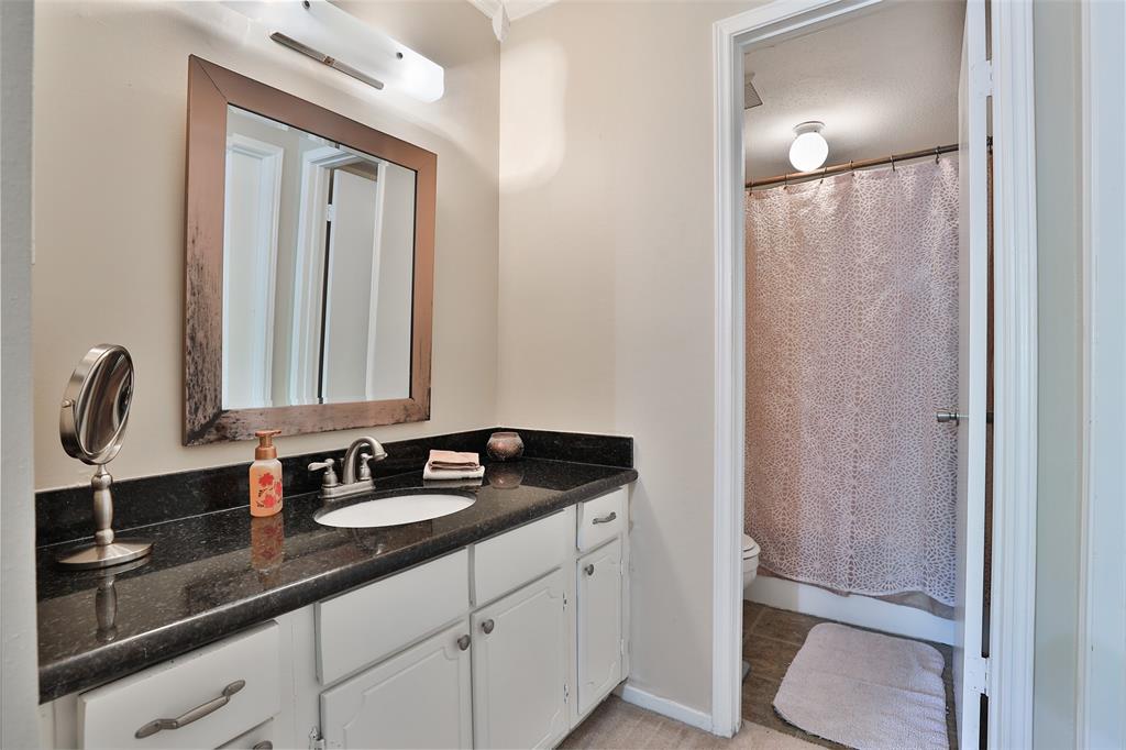 Primary bath!  This spacious area features granite counter top, lots of storage/cabinets,  tub with shower and a large walk in closet.