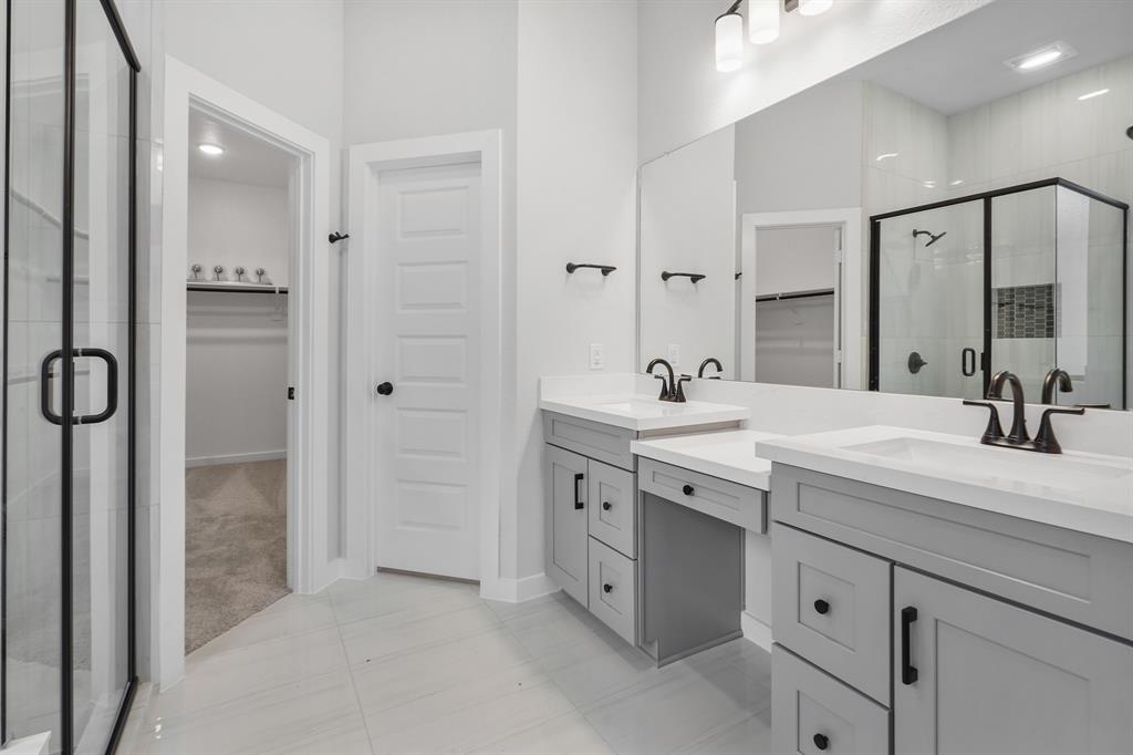 NEWMARK HOMES\' new construction Monaco features double split vanities with knee space, separate soaking tub and separate shower in the main bath.