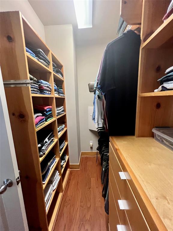 Another view of the primary closet with custom built-ins.