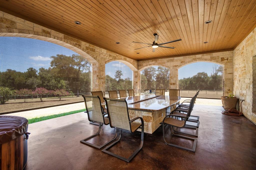 ENTERTAINING AREA ON LARGE REAR PORCH OVERLOOKING NORTH AND WEST GREENBELT