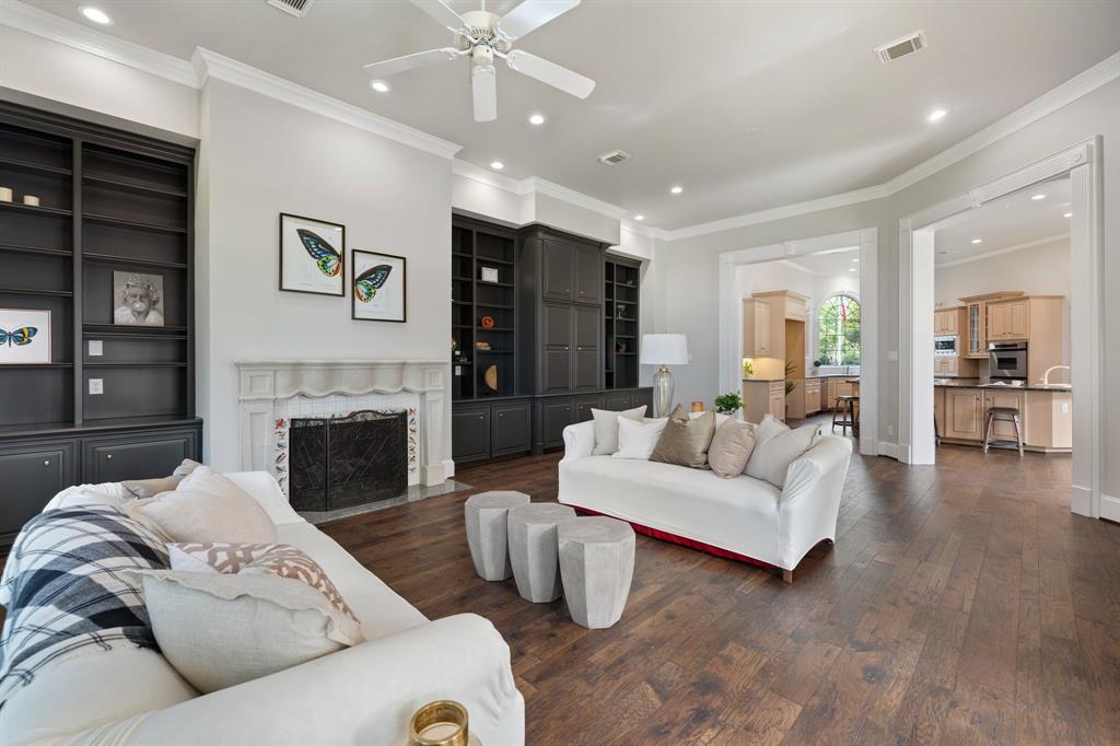 Spacious Family room takes center stage for the modern lifestyle. Custom built ins are stunning and the neutral paint color in here really pops.