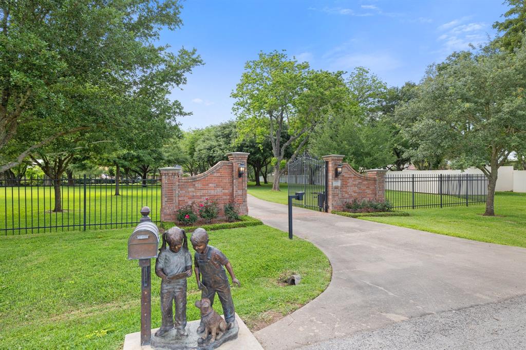 Enter your property from behind the brick and iron privacy fence and enjoy a winding path through mature oak trees as you feel the stress of the day melt away.