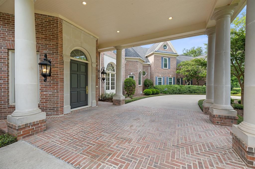 Grande porte-cochere up front with a herringbone brick pattern sets the tone of elegance as your guests arrive for your dinner party.