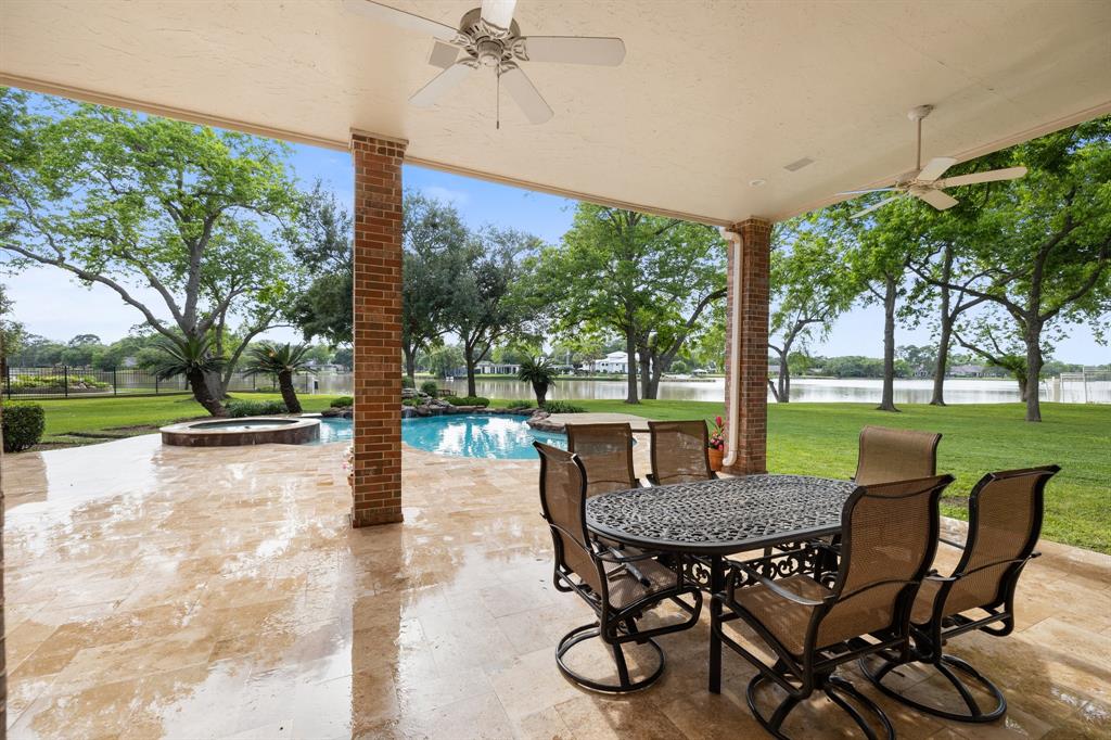 Unbeatable covered porch!  Plenty of room for outdoor furniture, and with the sun protection and fans, you really can enjoy this space all year long!