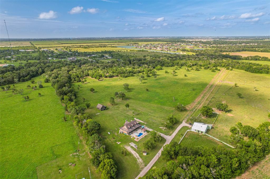 Exquisite 55 acre estate in Galveston County.  Rested amongst the tree lined banks of the Dickinson Bayou you'll enjoy the beauty of nature and feel your stress melt away. Riding and atv trails exist throughout the fully fenced property. 3 Horse stables are located inside the barn, along with a tack room. Complete with an RV hookup and parking site for guest. This sprawling ranchette is conveniently located only minutes to in town amenities but it is also within a 20 minute drive to the beach or a 30 minute drive to Houston. Step inside the beautiful 3/2.5 2380sqft home and you'll see why this is a rare gem. The home was professionally designed and decorated, resembling that of a "garden & gun" article. From the granite counters to the shiplap walls, no stone was left untouched. Remodeled in 2020 this gorgeous farmhouse is all one could wish for, nestled in the country setting yet so close to the comforts of town. 

Additional acreage available.