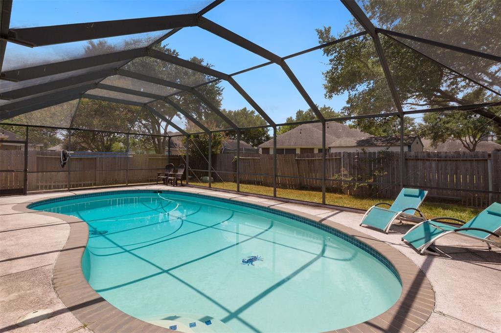 Another great view of the screened in pool and backyard area. Previous occupants said they could watch the Pecan Grove fireworks from the pool and backyard!!