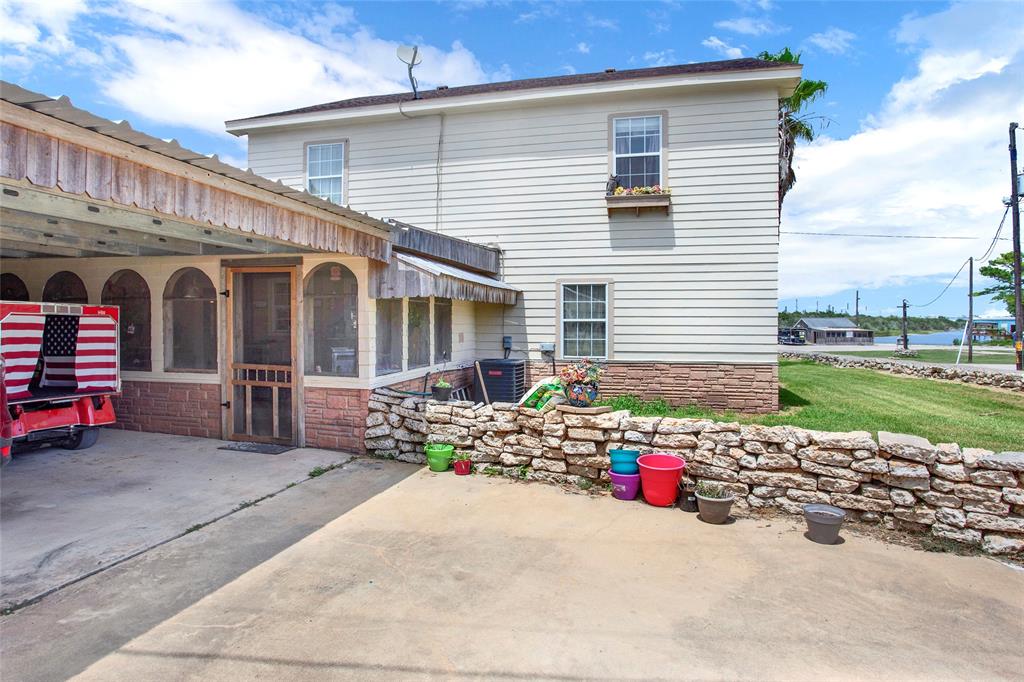 Back of the home.  Front faces the Tavern and water.  Screened in patio for more relaxing with out the pest!