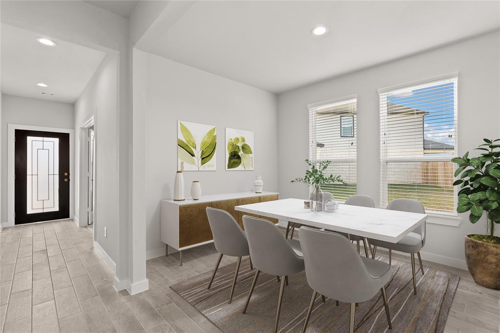 Make memories gathered around the table with your family and friends! This dining room features high ceilings, custom paint, gorgeous flooring and large windows with privacy blinds.