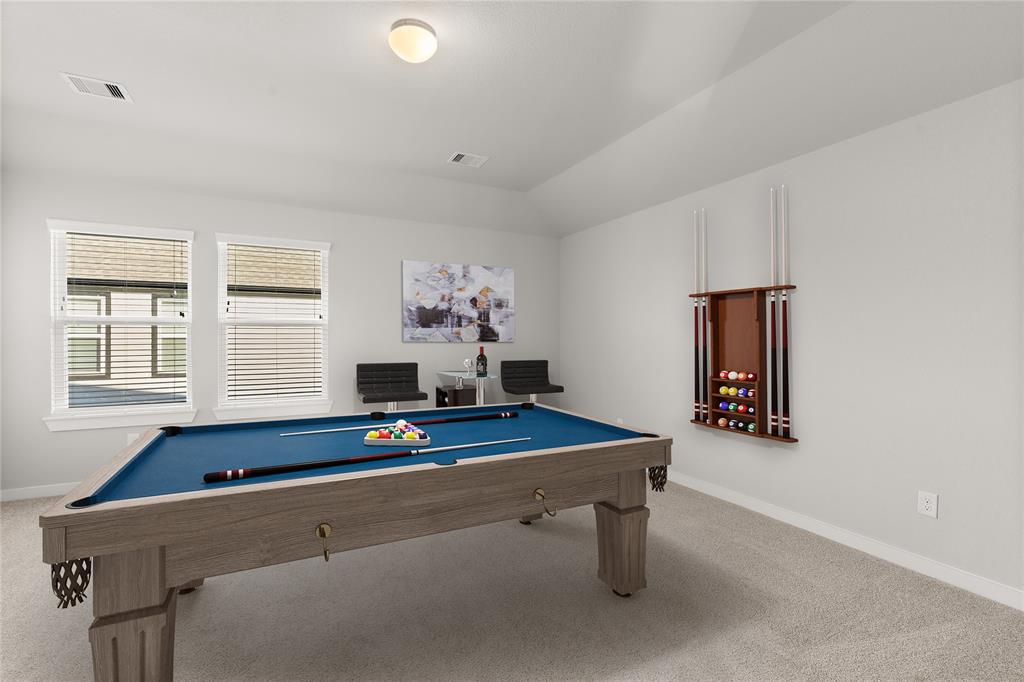 Come upstairs and enjoy a day of leisure in this fabulous game room! This is the perfect hangout spot or adult game room, this space features plush carpet, high ceiling, recessed lighting, custom paint and large windows with privacy blinds.