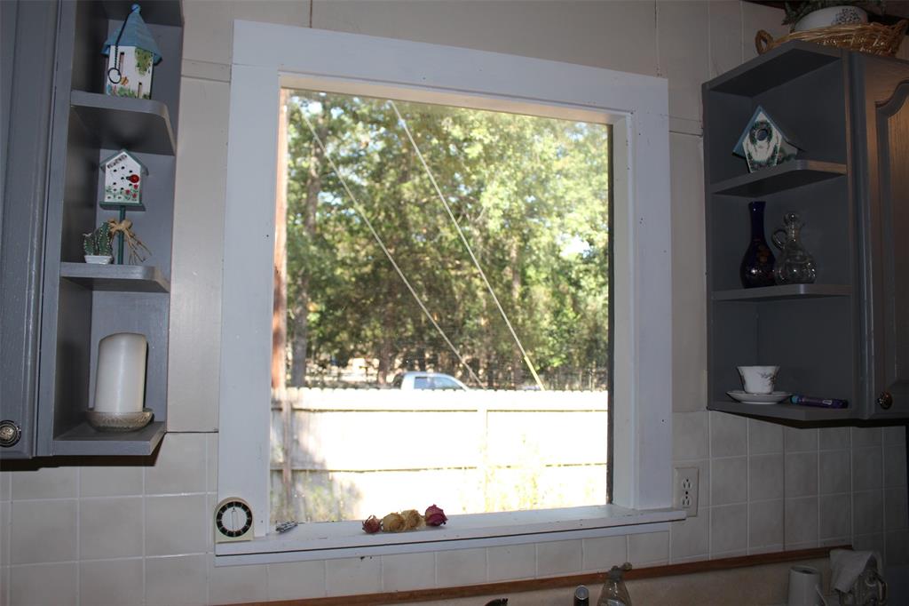 Gorgeous picture window over Kitchen sink. Watch the kids play in the back yard or let your fur babies roam. Back yard is fence and then larger fenced area, that includes the 60x40 shop.
