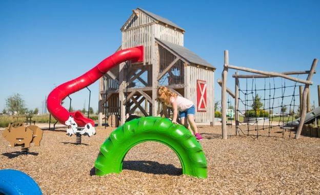 This huge playground features a custom-made climbable barn structure that can be seen from the highway! There is also plenty of room to run and play around several toddler-friendly playhouses!