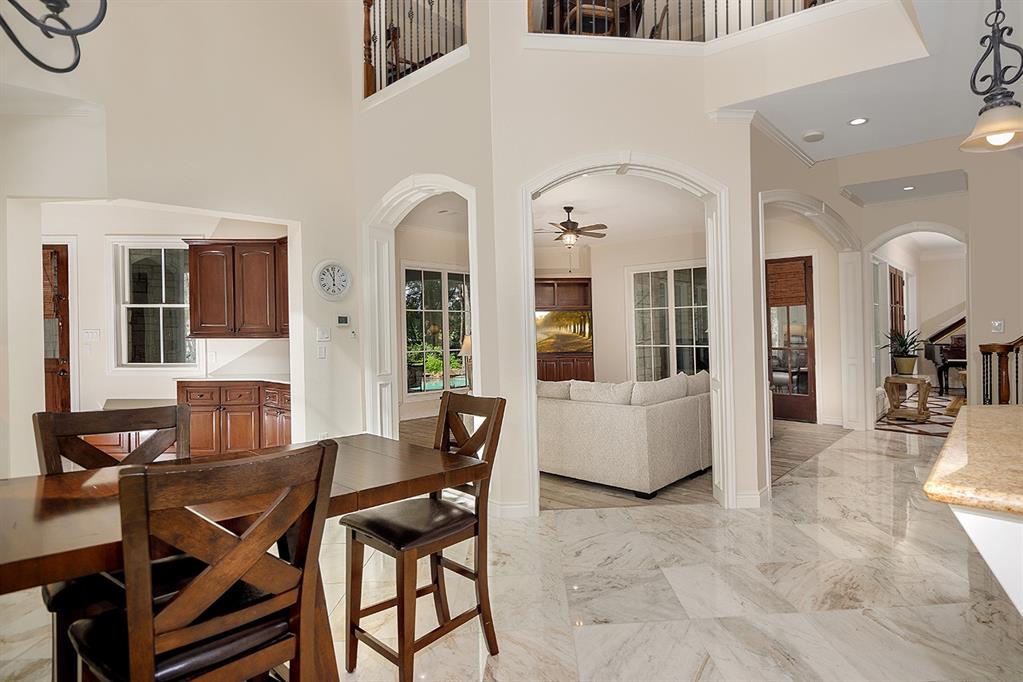 The two story breakfast room off the kitchen is where friends and family will gather