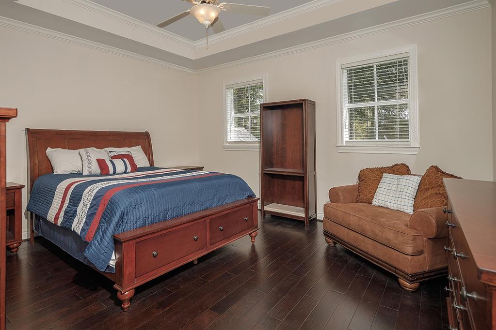 This guest bedroom has a tray ceiling, walk-in closet and en-suite bath