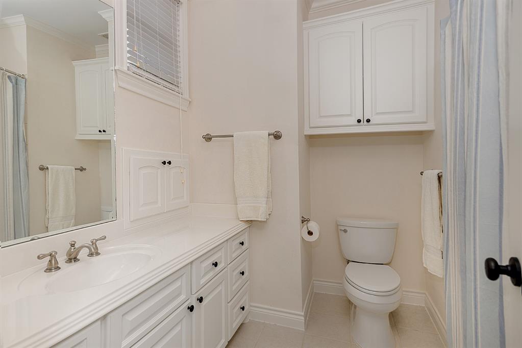 The bathrooms in this home are neutral and have plenty of cabinet storage