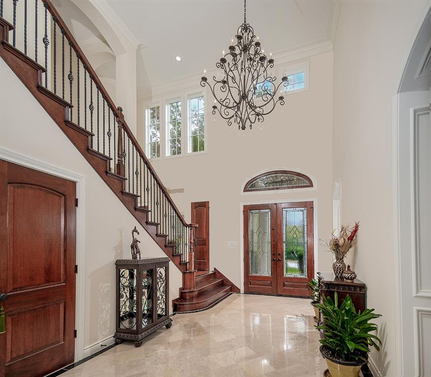 Impressive foyer showcases soaring ceilings, neutral paint and gorgeous trim work