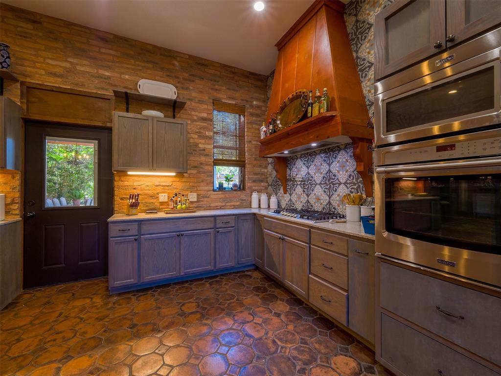 Kitchen with gas cooktop, electric oven and microwave.