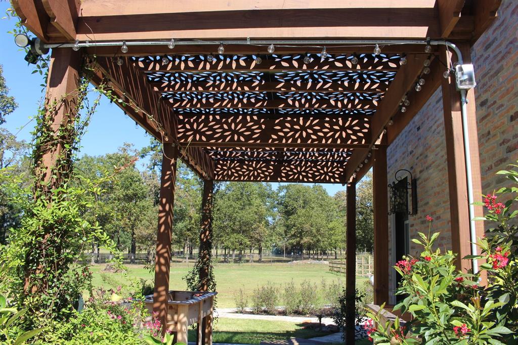 Pergola offers shade outside the kitchen door.