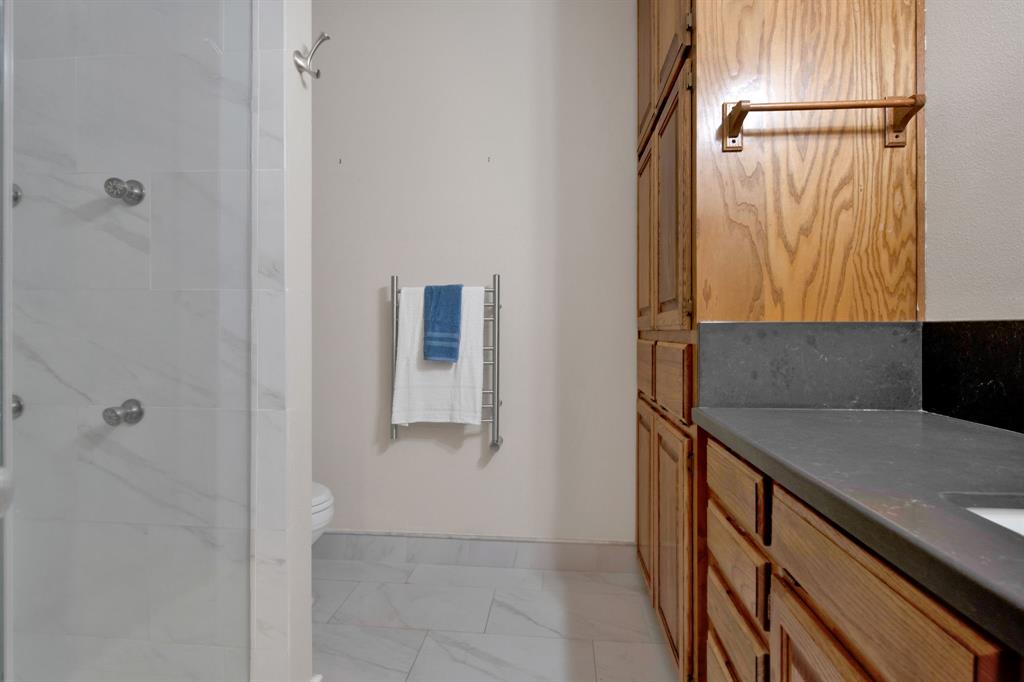 En-suite bathroom was renovated with quartz countertops, stunning tiled shower with glass door & a heated towel rack.