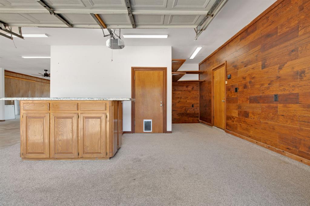 Additional parking options or workspace with outdoor storage options. Through the door is a 10 x 8 air conditioned room to be used for whatever your heart desires!