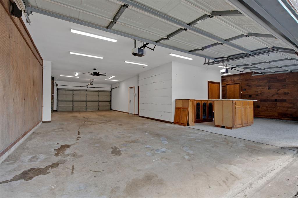 Option to open pull through garage door if desired. 3 auto garage doors, 2 entry access points to interior, a 10 x 8 air conditioned room + easy stair attic access for additional storage.