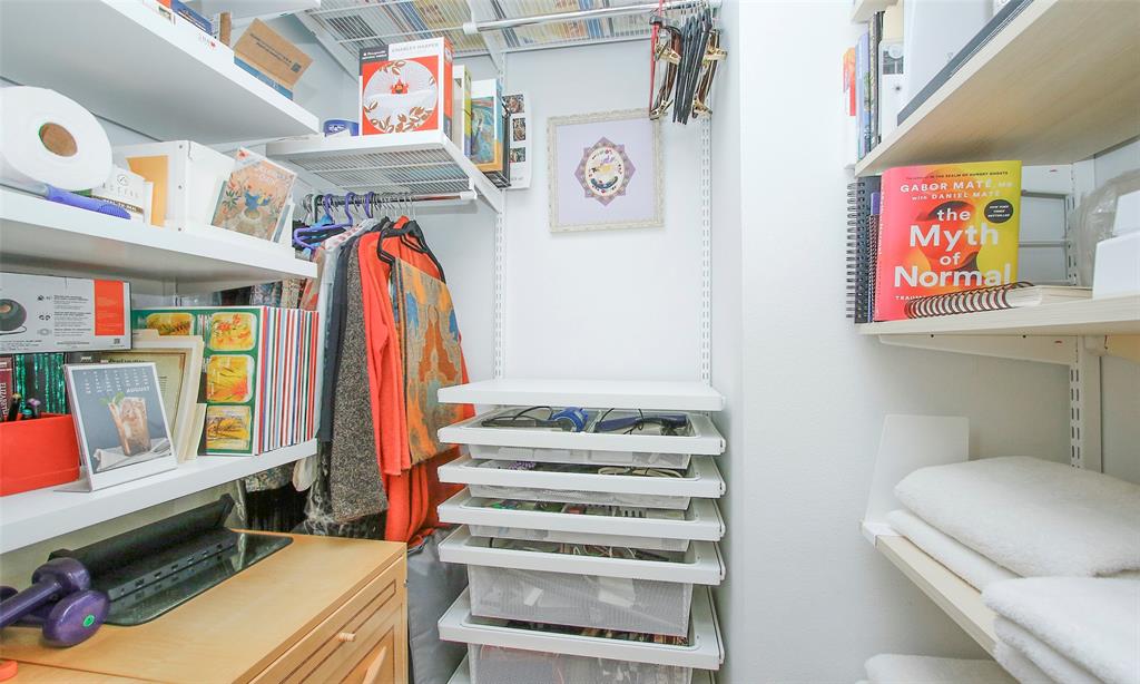 The closet has custom shelving and storage space.